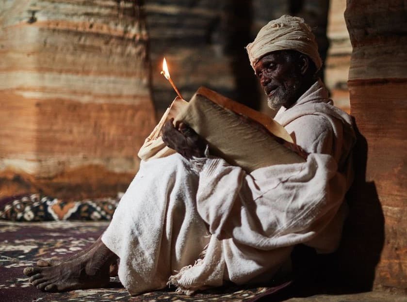 Priest reading a book